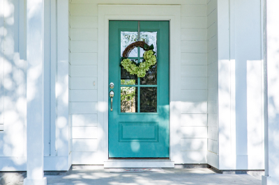 Bold, blue front door paint color on a white home.