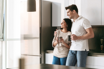 Couple in modern kitchen admires their home improvements.