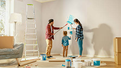 Family painting a room together in their new home