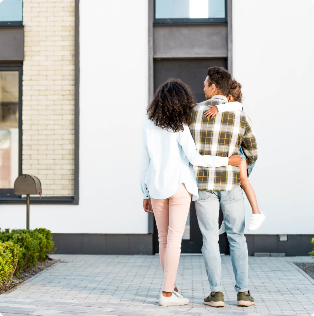 Family standing outside of their new home through CrossCountry Mortgage