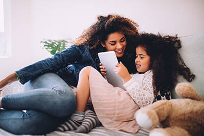 A mother and daughter attending virtual events