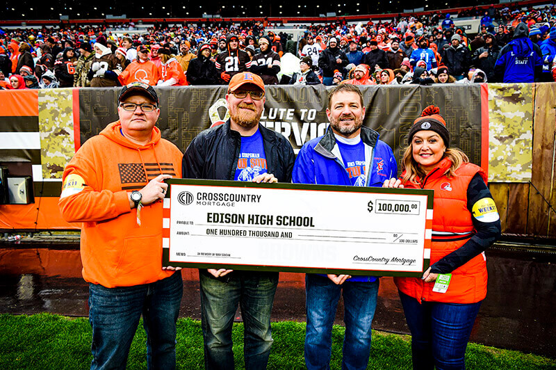 CBO Laura Soave presenting the $100,000 donation to Kip Soviak and Edison High Schools' Football Coaches