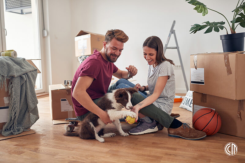 Couple and their puppy unpacking in their new home