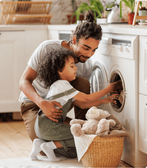 A father and daughter unload the dryer together in their energy-efficient home