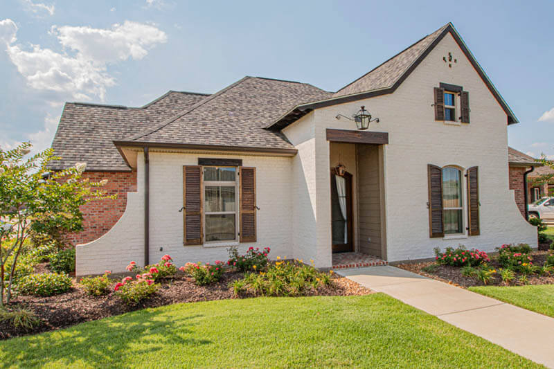 Exterior of cottage style home with whitewash brick style