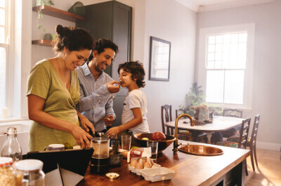 Hispanic family gathers in the kitchen of their purchased home.