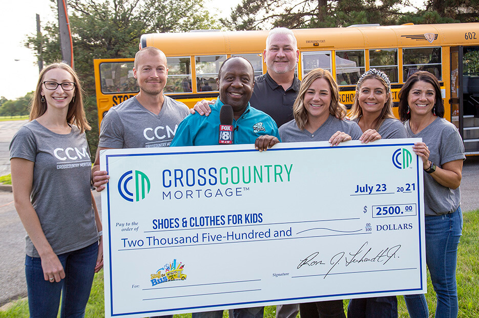 CrossCountry Mortgage employees delivered school supplies and a financial donation to the FOX 8 Stuff the Bus event