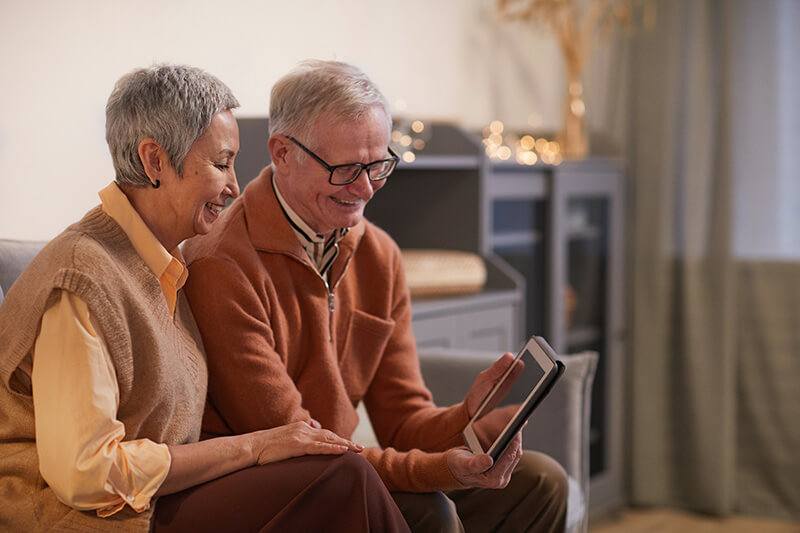 Senior couple browsing home financing options for their home renovation