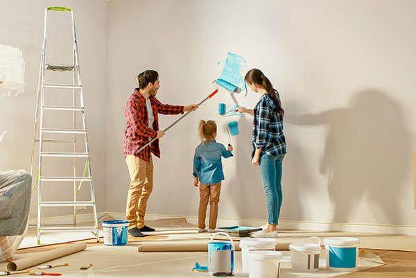 Family painting the walls of their new addition
