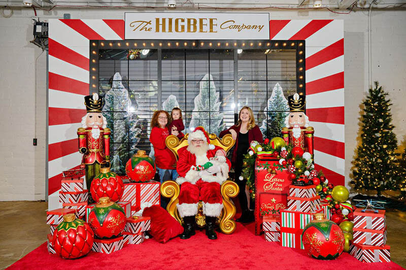 A family posing with Santa Claus at CCM headquarters